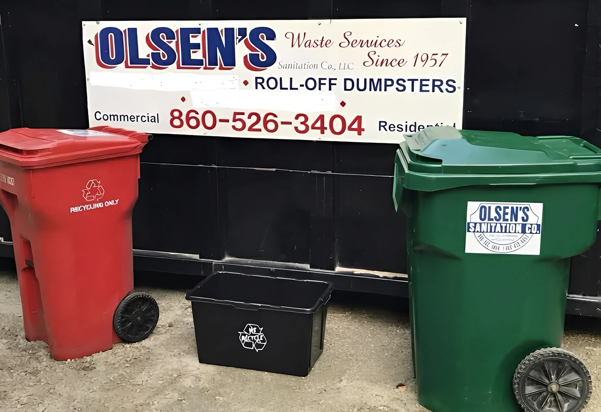 Red and green dumpsters with company sign.